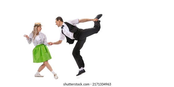 Expressive couple of dancers in vintage retro style outfits dancing social dance isolated on white background. Timeless traditions, 60s ,70s american fashion style. Dancers look excited - Shutterstock ID 2171334963