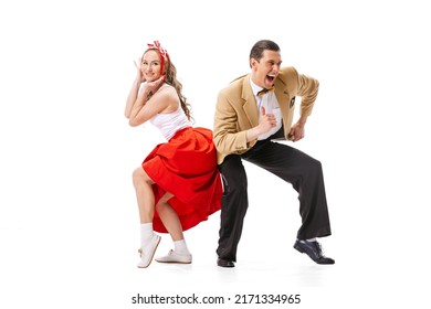 Expressive couple of dancers in vintage retro style outfits dancing social dance isolated on white background. Timeless traditions, 60s ,70s american fashion style. Dancers look excited - Shutterstock ID 2171334965