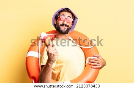expressive crazy bearded man wearing hat and sunglasses with an ice cream