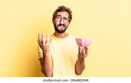 expressive crazy man looking desperate, frustrated and stressed and holding a pot - Powered by Shutterstock