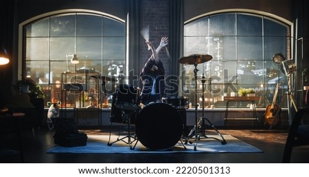 Expressive Drummer Girl Playing Drums in a Loft Music Rehearsal Studio at Night. Rock Band Music Artist Learning a New Drum Solo. Woman Preparing for Big Concert With Audience.