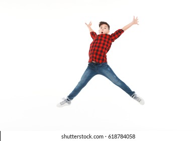 Expressive Excited Teenager In Casual Outfit In Moment Of Jumping High On White .