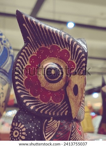 The expressive eyes of the wooden owl are expertly carved, lending a lifelike quality to the sculpture and infusing it with a sense of personality.