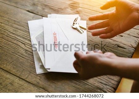 Expressive hands react to an overdue letter in an envelope - Financial hardship - Crisis