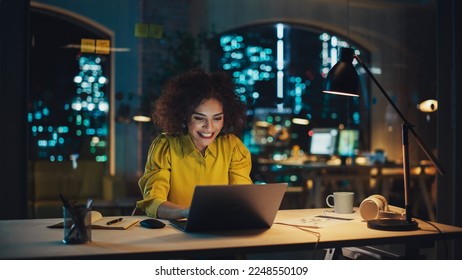 Expressive Multiethnic Middle Eastern Female Working on a Creative Job Position in an Advertising Company. Manager Brainstorming Ideas, Excited for the Selection of her Project. Office at Night.