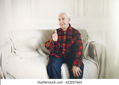 Expressive Old Man Giving Thumbs Up Isolated Against White Background.