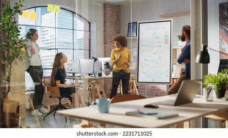 Expressive Project Manager Talking on a Team Meeting in Creative Agency Conference Room. Arab Female Showing Business Plan Presentation. Project Plan Presentation on Digital Whiteboard Monitor - Powered by Shutterstock