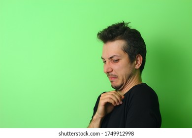 Expressive Young Man Or Guy On A Light Green Background. Emotion Of Disgust