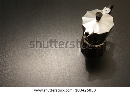 an expresso maker in dramatic lighting.
