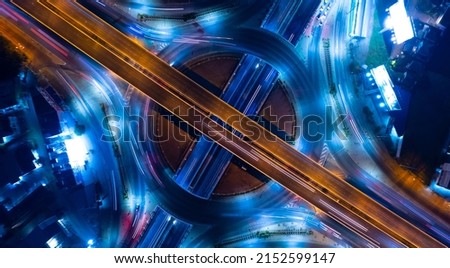 Expressway top view, Road traffic an important infrastructure,car traffic transportation above intersection road in city night, aerial view cityscape of advanced innovation, financial technology