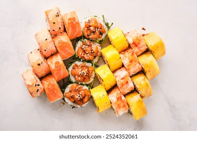 An exquisite assortment of sushi rolls, showcasing a variety of colors and textures, is beautifully arranged on a marble surface. Each roll tempts with fresh ingredients. - Powered by Shutterstock