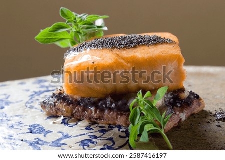 Exquisite culinary creation featuring pan seared salmon with poppy seeds, fresh herbs, and toasted bread, creating a gourmet dining experience