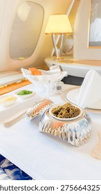 An exquisite fine dining experience aboard a luxury aircraft, featuring a gourmet meal and elegant table setting, perfect for travel and hospitality marketing.