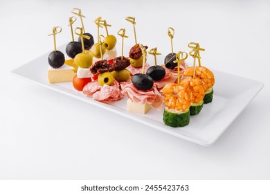 Exquisite gourmet finger food appetizer platter with an elegant assortment of cheese. Shrimp. Olives. Salami. Cucumber. Grape. And sundried tomato. Perfect for catering. Parties. And banquets - Powered by Shutterstock