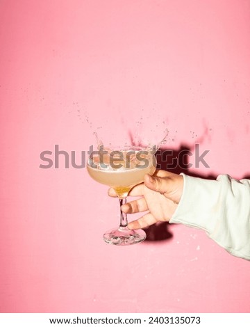 Exquisite Martini and Splashing Cocktails in Vibrant Pink Background - Captivating Stylized Photography Showcasing Delicate and Delicious Mixology