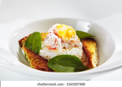 Exquisite Serving Crab Cake Napoleon With Pike Caviar Sauce On White Restaurant Plate Isolated. High Cuisine Restaurent Seafood Dish With King Crabs Meat And Croutons In Modern Minimalist Style