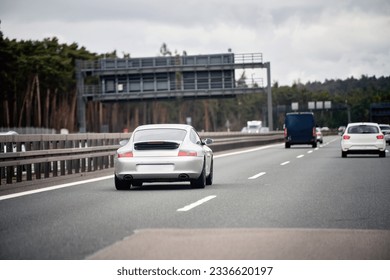 Exquisite Speed and Style on the Highway. Modern European Sportcar. Silver German roadster vehicle on the highway. Silver sport coupe. The expensive sports car on public roads. Autobahn speeding - Shutterstock ID 2336620197