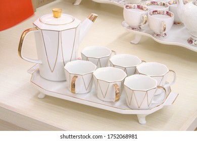 Exquisite white ceramic tea set, white teapot and six cups on the table