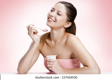 Exquisite Woman With Yogurt / Studio Photography Of Brown-eyed Brunette Girl Holding Spoon And A Container Of Yogurt - On Blurred Background 