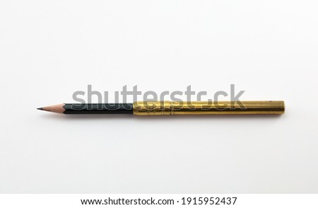 Extend, enlarge, increase, concept image, a short pencil in a brass pencil extender, isolated on neutral white. 