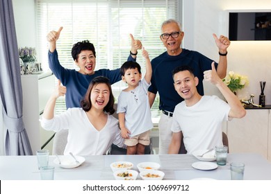 Extended Asian Family Of Three Generations Having A Meal Together And Showing Thumbs Up At Home With Happiness