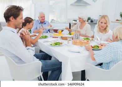 Extended Family At The Dinner Table In Kitchen