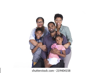 Extended family of grandmother, parents and grandchildren smiling isolated on a white background