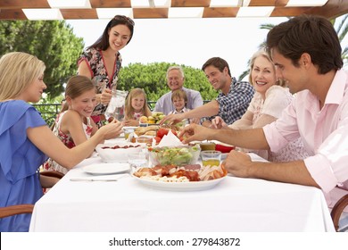 Extended Family Group Enjoying Outdoor Meal Together