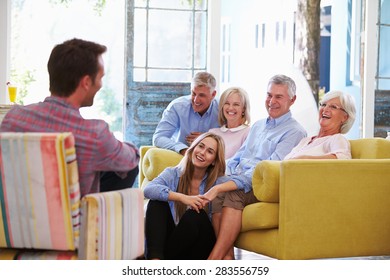 Extended Family Group At Home Relaxing In Lounge