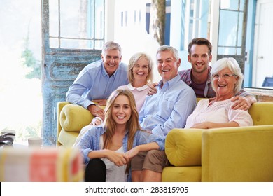 Extended Family Group At Home Relaxing In Lounge