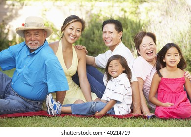 Extended Family Group Relaxing In Garden