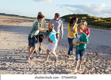 Extended Family Group Walking Along Beach