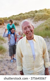 Extended Family Group Walking By Sand Dunes