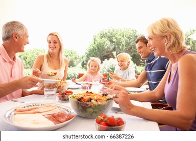 Extended Family, Parents, Grandparents And Children, Eating Outdoors