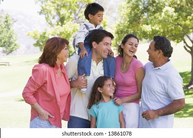 Extended family at the park smiling - Powered by Shutterstock