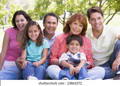 Extended Family Sitting Outdoors Smiling