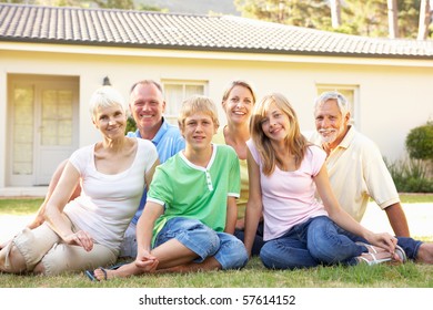 Extended Family Sitting Outside Dream Home