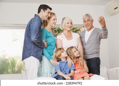 Extended Family Taking Group Photo At Home