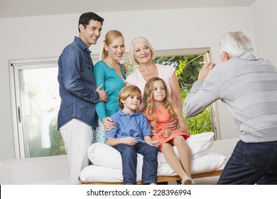 Extended Family Taking Group Photo At Home