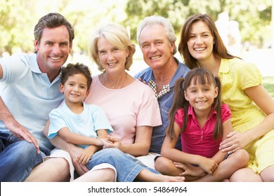 Extended Group Portrait Of Family Enjoying Day In Park