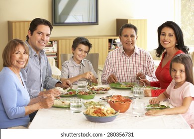 Extended Hispanic Family Enjoying Meal At Home