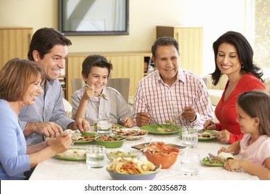 Extended Hispanic Family Enjoying Meal At Home