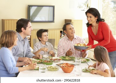 Extended Hispanic Family Enjoying Meal At Home