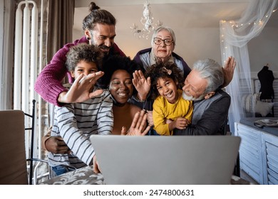 Extended multiethnic family together at home during video call. People happiness technology concept - Powered by Shutterstock