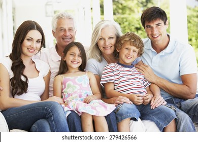 Extendend Family Sitting In Garden