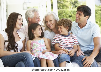 Extendend Family Sitting In Garden