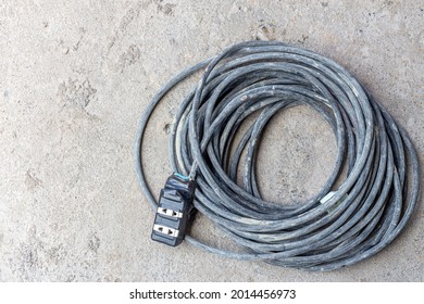 The Extension Power Strip, Power Cord Old And Damaged On The Construction Site Outdoor. Extremely Dangerous, Not Safe If In Use. Should Be Replaced. Unsafe Workplace