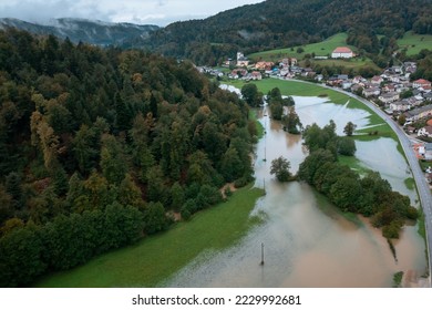 Extensive deluge across Europe, flooded mountain valley, near the households area and traffic ways, drone shot. Extreme climate event. - Shutterstock ID 2229992681