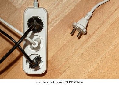 Extention cord, Extension cable with three plug socket  on wooden  background. Copy space