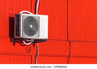 Exterior Airconditioning Unit On A Red Wooden Wall